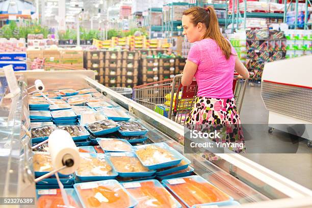 Woman Shopping For Fresh Fish Seafood In Supermarket Retail Store Stock Photo - Download Image Now