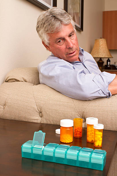 istock Senior Man Stares at Medications 523277497