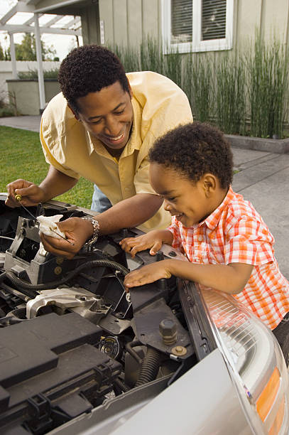 istock Father And Son Examining Car Engine In Yard 523278201