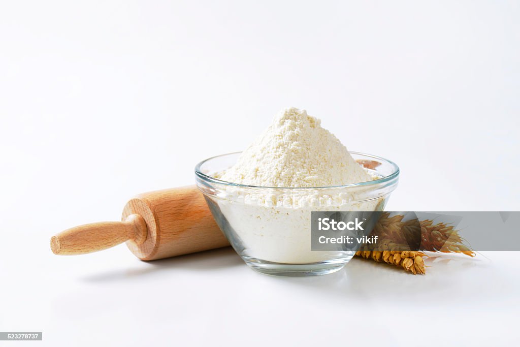 Wheat flour and rolling pin Bowl of flour, rolling pin and wheat ears Bowl Stock Photo