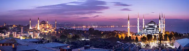 Panoramic view of the Blue Mosque and Hagia Sophia (right) in the Sultanahmet District of Istanbul, Turkey at twilight.