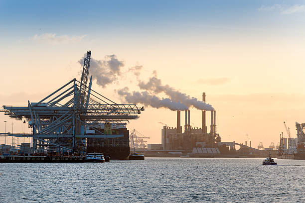 Container ship in cargo dock in industrial area.