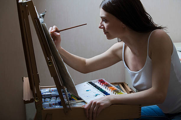 istock Woman Painting On Easel 523291503