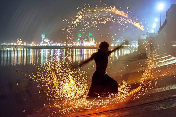 Male dancer silhouette in circle of sparks Young man dancing with flame at night on embankment of city. Shot with using a long exposure spinning photos stock pictures, royalty-free photos & images