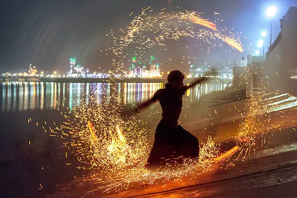 Photo of Male dancer silhouette in circle of sparks