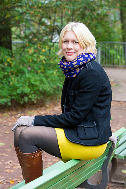istock woman sitting on a bench 523293375