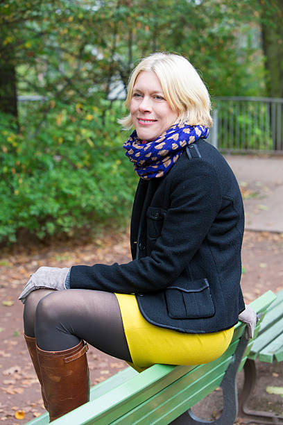istock woman sitting on a bench 523293377
