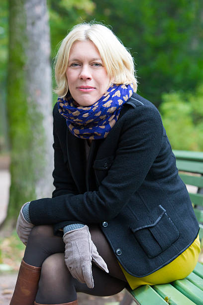 istock woman sitting on a bench 523293379