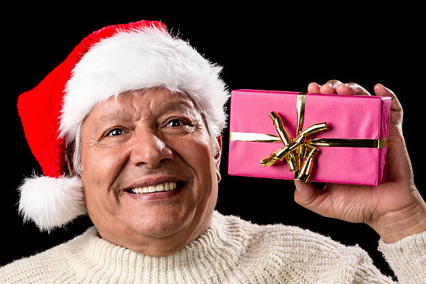 istock Excited Old Man With Santa Cap And Magenta Gift 523311525