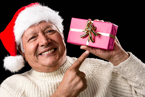 istock Aged, But Vivid Gentleman Pointing At Wrapped Gift 523311639