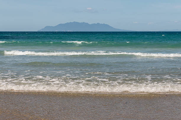 istock tidal waves with silhouette of island on horizon 523312731
