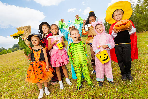istock Children in different Halloween costumes standing 523314625