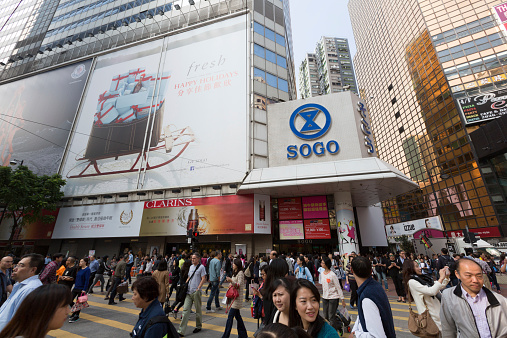 Hong Kong, Hong Kong SAR - November 14, 2014: Pedestrians walk past Hennessy Road in Causeway Bay Shopping District, Hong Kong.