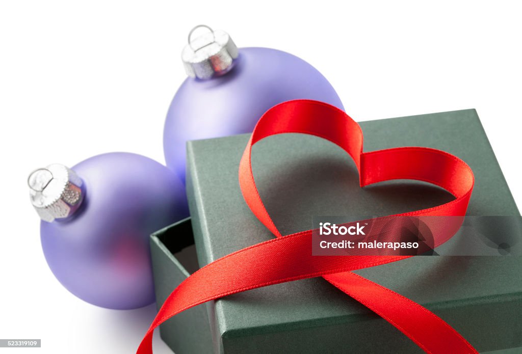 Christmas present. Gift box with ribbon in heart shape. Christmas present. Gift box with ribbon in heart shape. Photo with clipping path. AIDS Awareness Ribbon Stock Photo