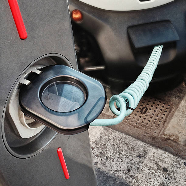 istock Charging up an electric car at roadside 523319113
