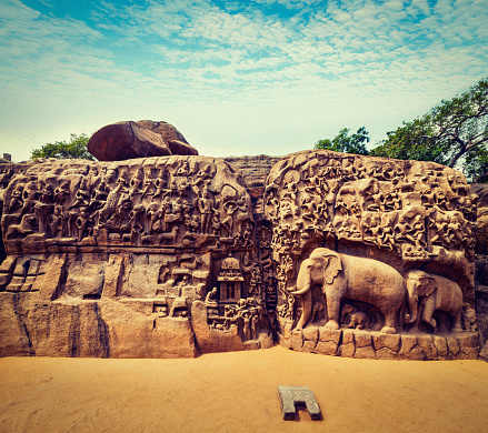 Vintage retro hipster style travel image of Descent of the Ganges and Arjuna's Penance ancient stone sculpture - monument at Mahabalipuram, Tamil Nadu, India