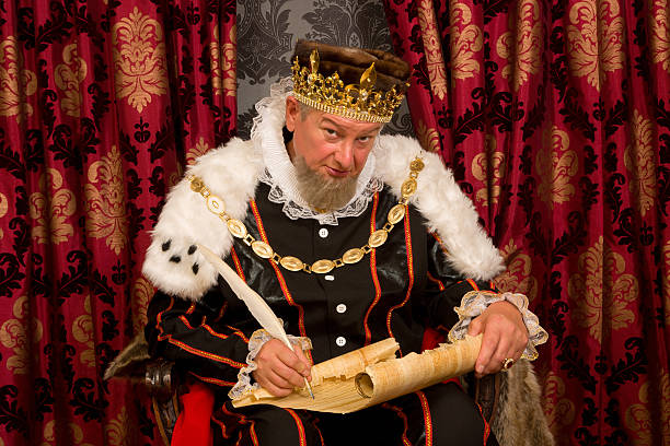 King signing new law Old king signing a new law with a feather quill cosplay photos stock pictures, royalty-free photos & images