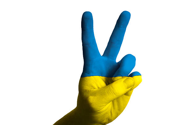 Hand with two finger up gesture in colored ukraine national flag as symbol of winning, victorious, excellent, - for tourism and touristic advertising, positive political, cultural, social management of country