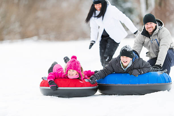 istock Family Tubing in Winter 523355103