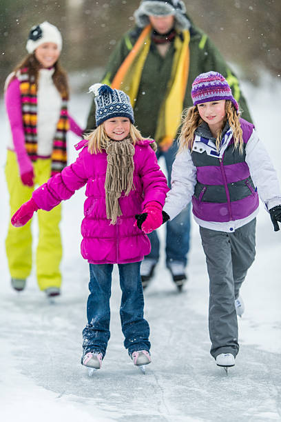 istock Family Ice-Skating on Pond 523355791