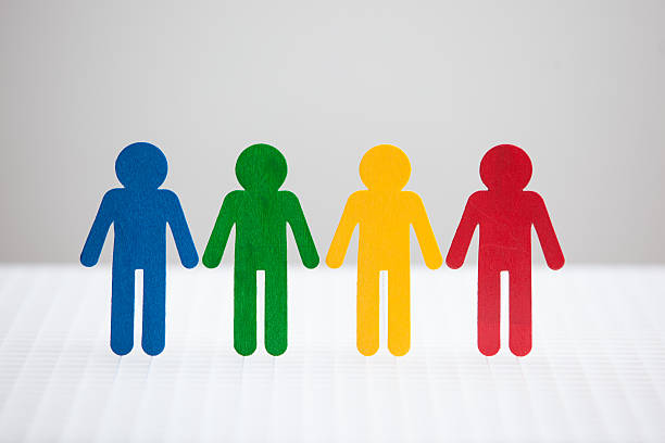 Four persons in various colors on a white background stock photo