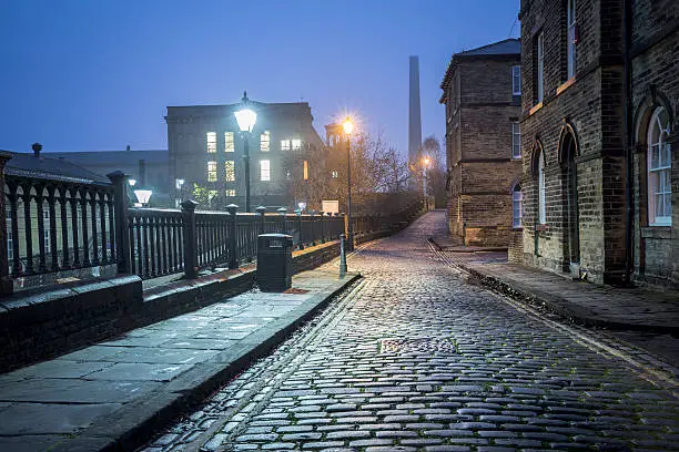 Old cobbled streets in Saltaire, Bradford at night. 