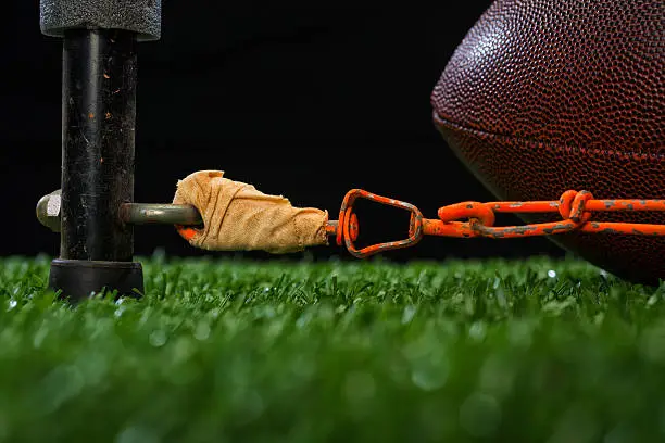 American Football - Fourth and Inches. A low angle view of the measurement to see if you reach a first down and you come up short, so it is 4th and inches.