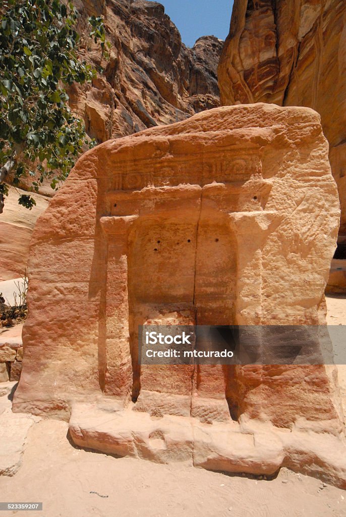 The Siq in Petra, Jordan Petra, Jordan: carved entrance in a monolith in the Siq, a dim, narrow gorge, a natural geological fault split apart by tectonic forces, leading from Wadi Musa to the the Khazneh / Treasury - UNESCO world heritage site - photo by M.Torres Ancient Civilization Stock Photo