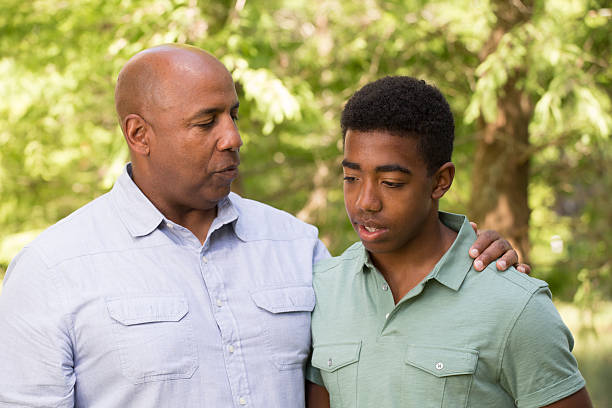 istock African American Father And Son Talking 523360243