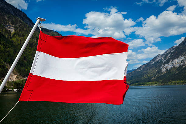 istock Austrian flag agains mountain lake 523360445