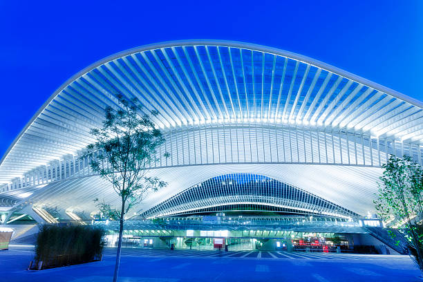 Futuristic Railway Station Building Illuminated at Night futuristic building of a railway station illuminated at night, Liege, Guillemins, Belgium liege belgium stock pictures, royalty-free photos & images