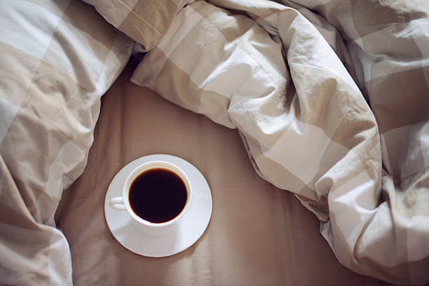 istock cup of coffee on the bed 523375924