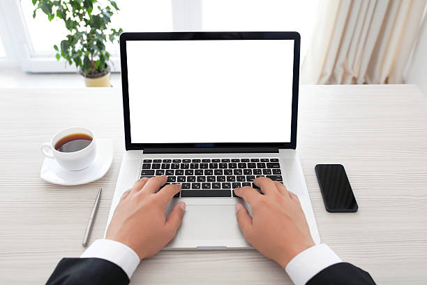 istock businessman sitting behind a laptop with isolated screen 523377787