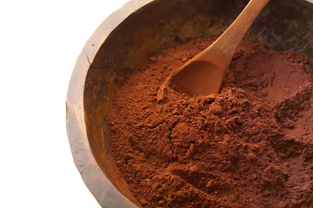 a bowl of cocoa powder with spoon