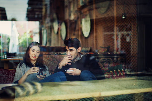 Turkish Couple in Cafe Use Tablet stock photo