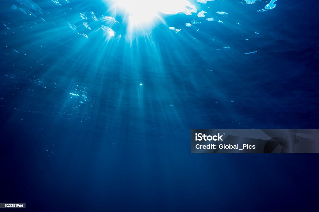 Sunbeam - Palau, Micronesia Rays of light cross the waterline in a tropical beach Underwater Stock Photo