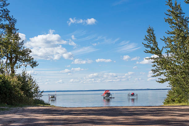 two boats and a sea doo docked  close to shore