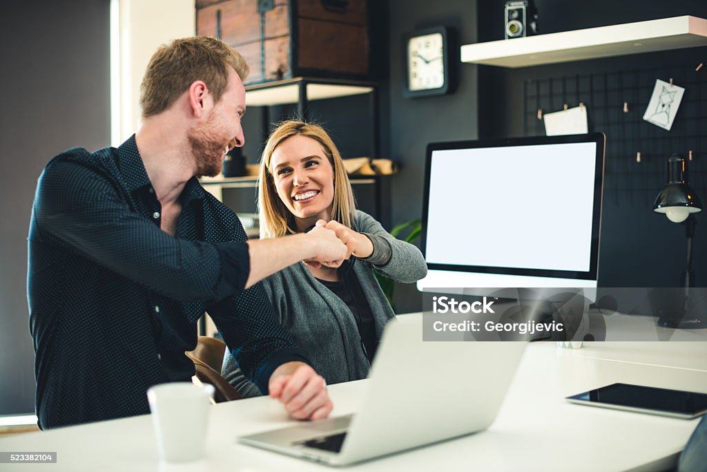 We did it! Successful team celebrating success together. Fist Bump Stock Photo