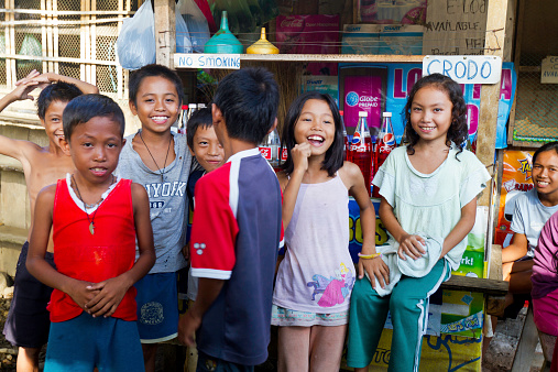 Caraga, Davao Oriental, Philippines – October 09, 2011: Group of children at play at petrol station in Caraga. Caraga is a coastal community in Davao Oriental Province of Mindanao.