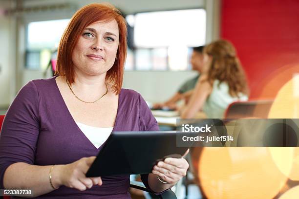 Confident Female Designer Working On A Digital Tablet In Red Stock Photo - Download Image Now