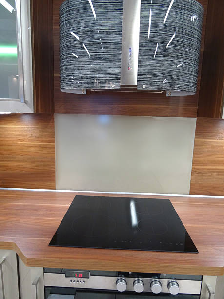 istock Modern kitchen, touch built-in ceramic hob cooker, glass-cabinets, wooden-worktop, splashback 523383197