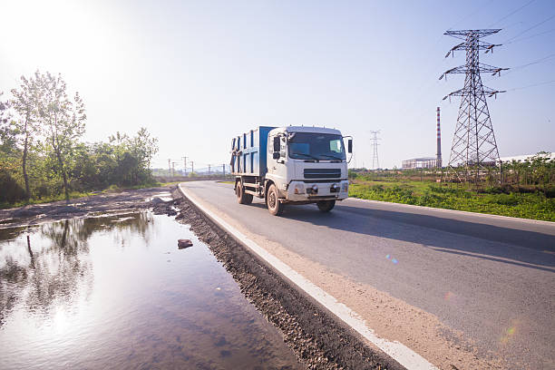 istock garbage truck running on the road 523383652