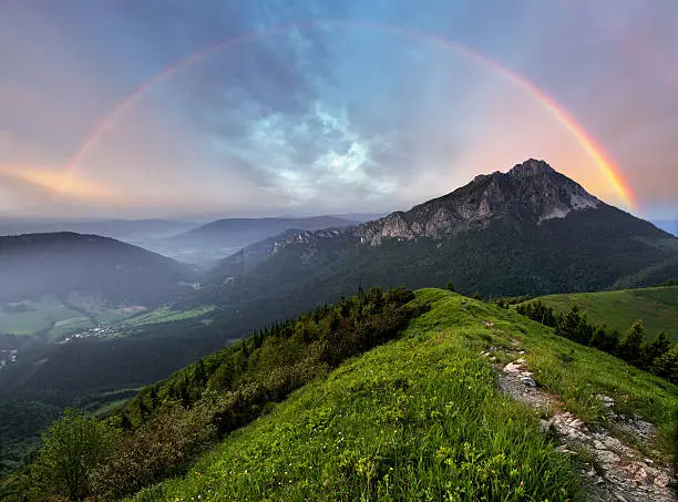 Rainbow over mountain peak