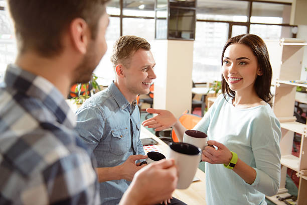 istock Positive smiling colleagues drinking coffee 523386696