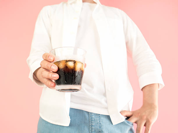 istock Asian man holding a grass of iced coffee 523386984