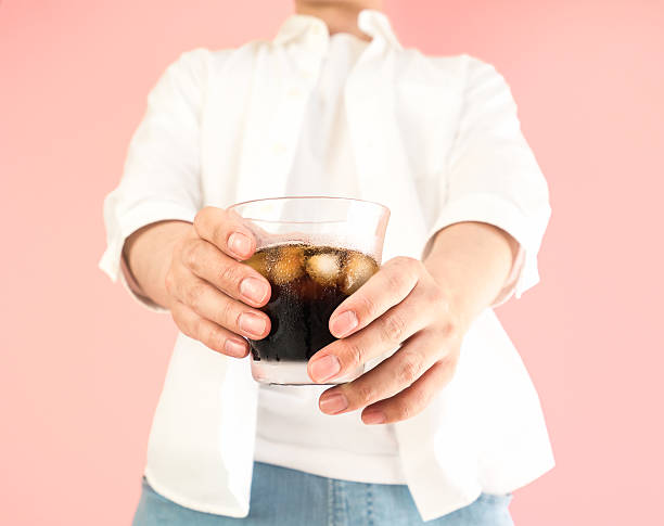 istock Asian man holding a grass of iced coffee 523387016