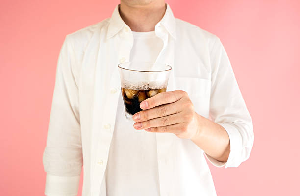istock Asian man holding a grass of iced coffee 523387046