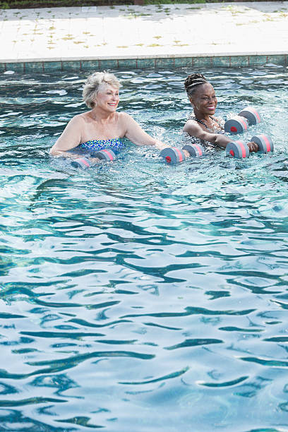 istock Senior women in pool doing water aerobics 523387960