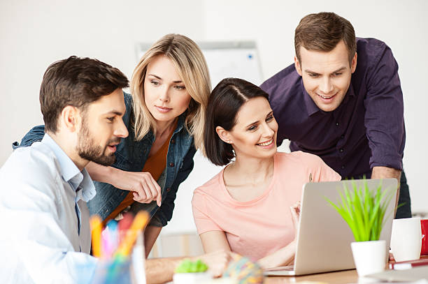 istock Cheerful young office workers are discussing a project 523388860