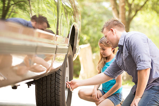 istock Daughter learning from father. Dad, child with tools, repairing vehicle. 523390036